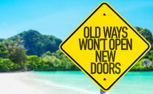 Old Ways Wont Open New Doors sign with beach background
